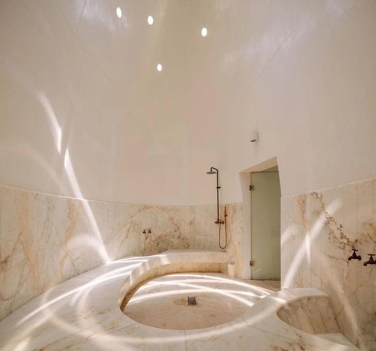 Marble bathtub with veining, soft lighting