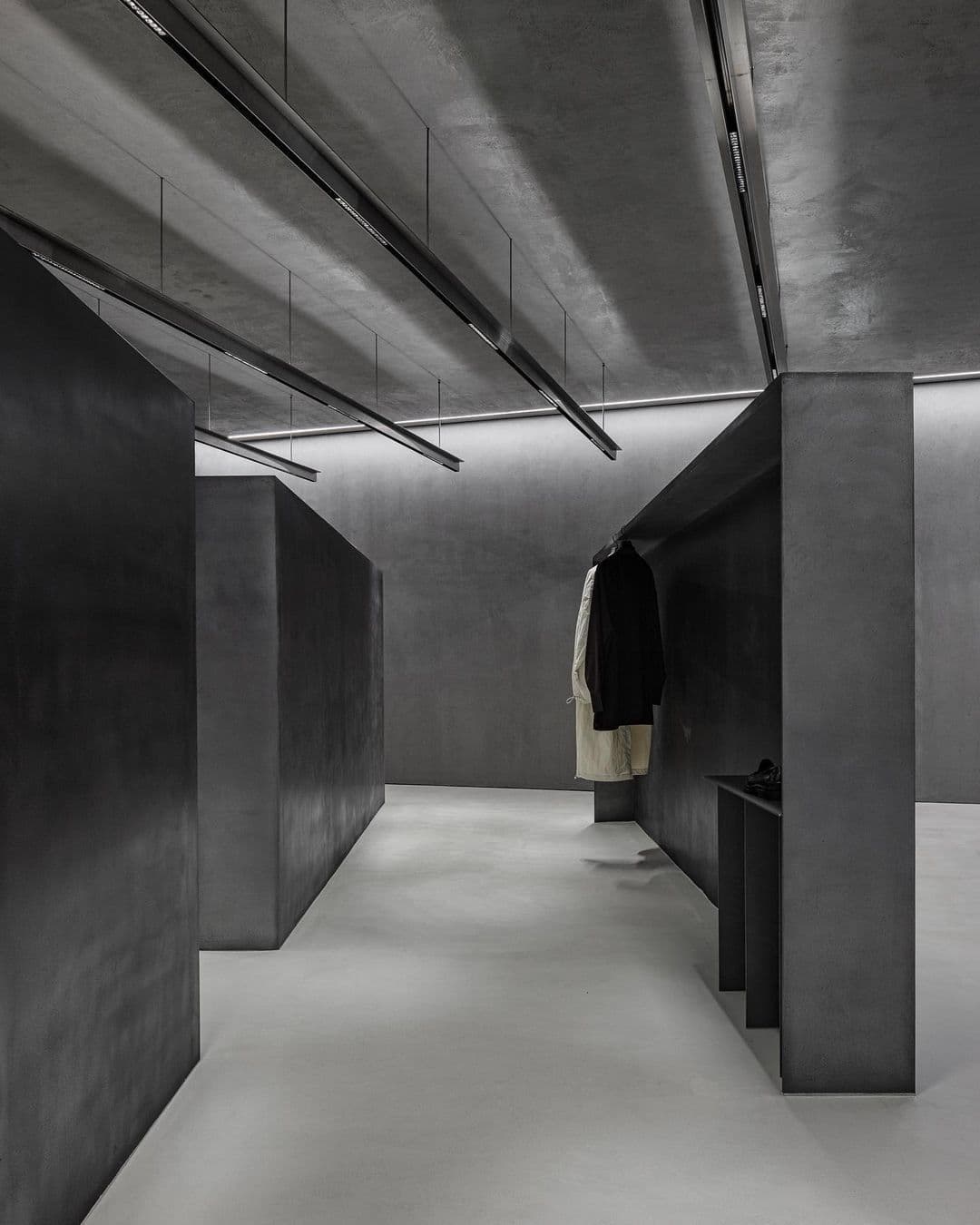 Boutique with matte black walls and mineral display units